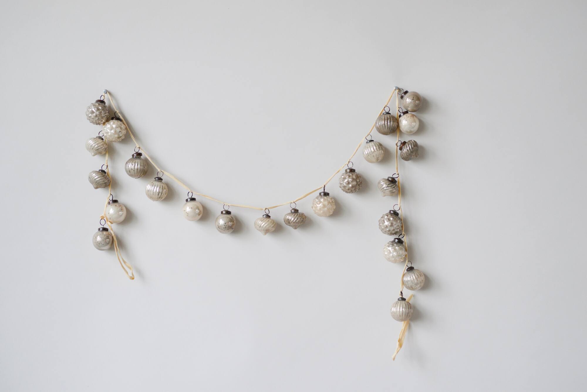 Hello Honey® 6ft. Silver & White Embossed Mercury Glass Ornament Garland